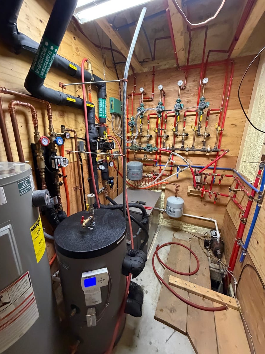 IGS geothermal mechanical room — PEX manifold, buffer tank, hydronic controls, Binghamton NY