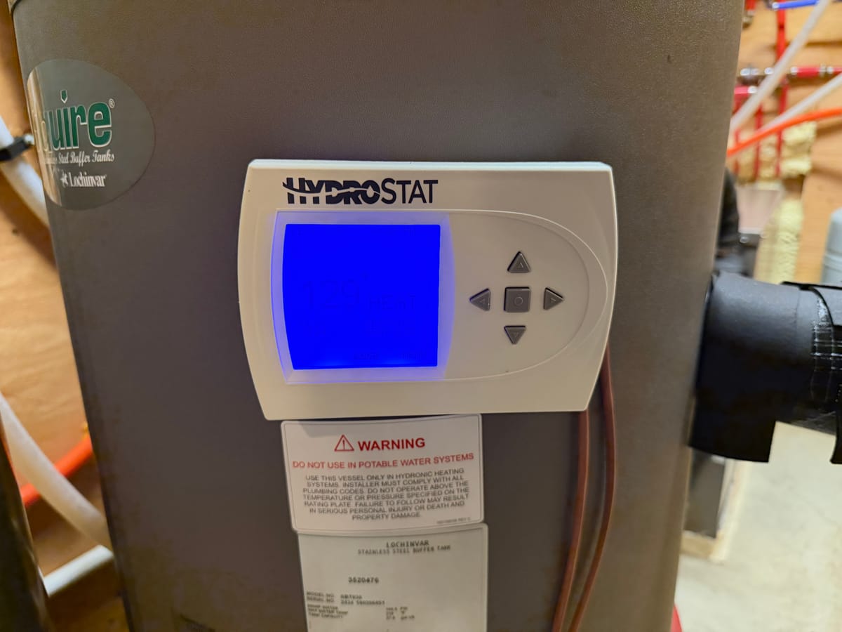 IGS geothermal system running — Hydrostat control reading 129°F heat on Lochinvar buffer tank
